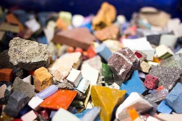 A pile of raw cut tile and stone offcuts in mixed colours